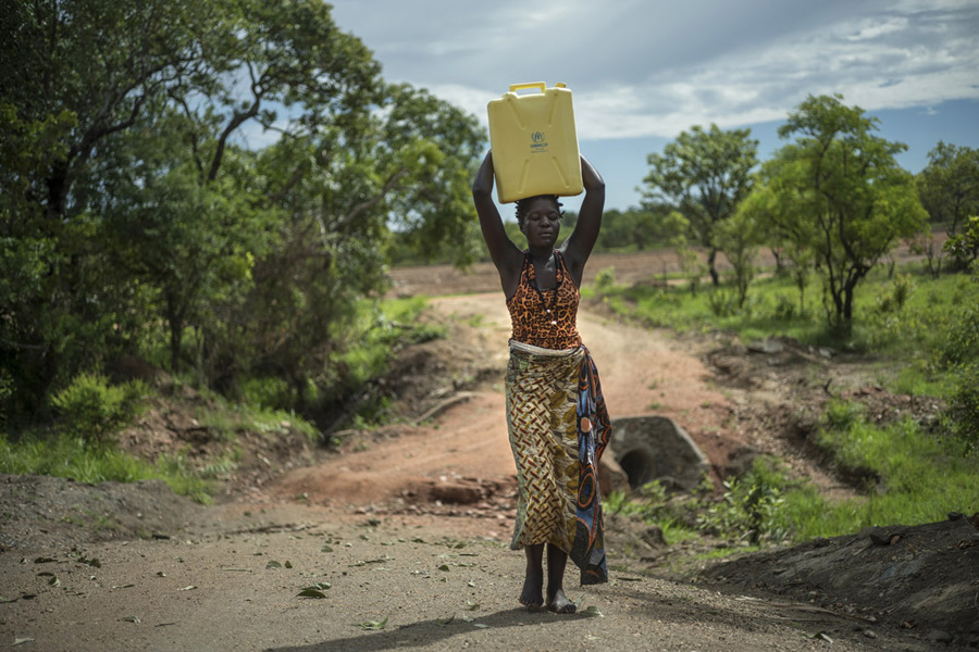 Beatrice carrying some water in Imvepi Refugee Settlement, Uganda. Photo: Kieran Doherty /Oxfam