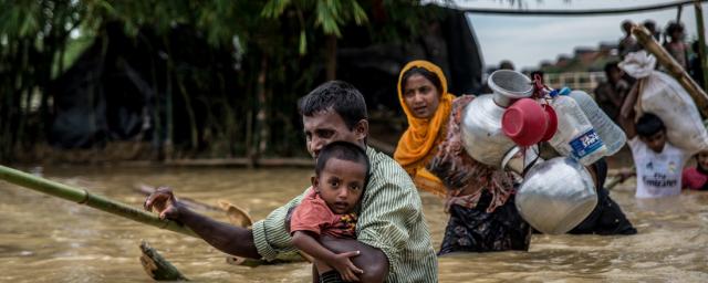 Un padre y su hijo cruzan un puente derrumbado cerca del campamento de Balhukali, en Bangladesh. Las lluvias torrrenciales obligan a los refugiados a desplazarse a zonas más elevadas. Foto: Aurélie Marrier d'Unienville