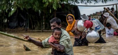 Un padre y su hijo cruzan un puente derrumbado cerca del campamento de Balhukali, en Bangladesh. Las lluvias torrrenciales obligan a los refugiados a desplazarse a zonas más elevadas. Foto: Aurélie Marrier d'Unienville