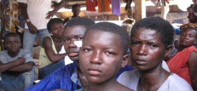 A sister and brother mourn the death of their father, a cocao farmer, in Ivory Coast