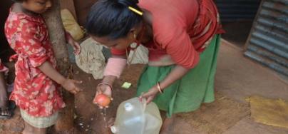 A mother and daughter wash fruit in Khadgabhanjyang, Nepal