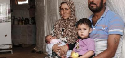 A Syrian refugee family sit in the tent where they now live, in an informal settlement, Bekaa Valley, Lebanon. 