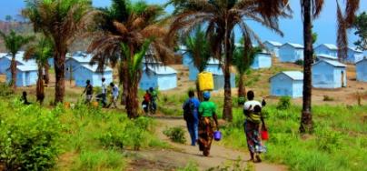 Burundian refugees carry jerrycans of water inside the Lusenda camp, Democratic Republic of Congo