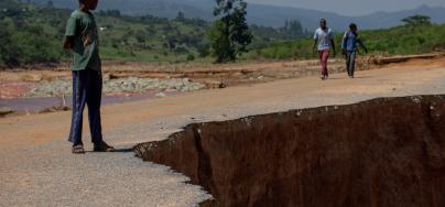 A boy looks at a section of road that was washed away in the flooding caused by Cyclone Idai, near Chimanimani, Zimbabwe, pictured on 29 March 2019. Credit: Philip Hatcher-Moore/Oxfam.