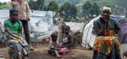 Une famille devant son abri temporaire dans le camp de personnes déplacées internes de Buporo, Nord Kivu, RDC, décembre 2014. Photo : Eleanor Farmer/Oxfam