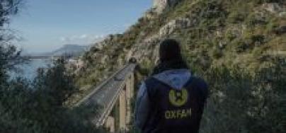 Adoum Ismail, a cultural mediator for Oxfam, looks at a highway bridge close to the border of France and Italy. Migrants often walk this road on their way to France. Photo: Agostino Loffredi/Oxfam