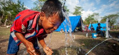 Palu, Indonesia: Arif washes his face with clean water pumped from an Oxfam Skyhydrant water filter. Credit: Keith Parsons/Oxfam