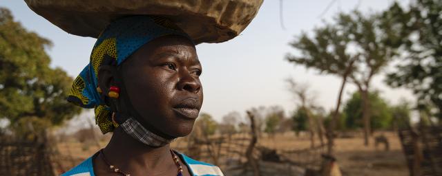 Aguiratou Ouedraogo fetches water from a well to water her market gardening crops.