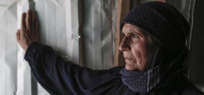 Amna from Deraa in Syria sits inside her caravan in Zaatari camp in Jordan. Photo: Sam Tarling