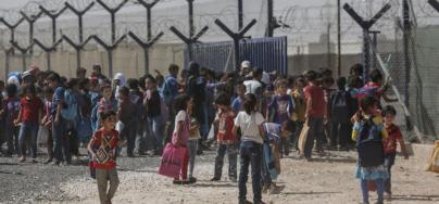 Syrian children gather outside a school in Zaatari refugee camp in Jordan, on September 21, 2015. As a host country Jordan is estimated to spend $870 million a year supporting Syrian refugees. Photo: Sam Tarling/Oxfam