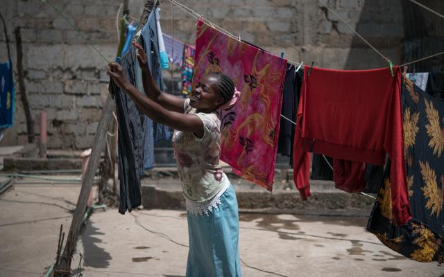 Tabitha Mwikali, 36, a domestic worker hanging clothes for her employer in Eastleigh, Nairobi, Kenya. Credit: Allan Gichigi/Oxfam