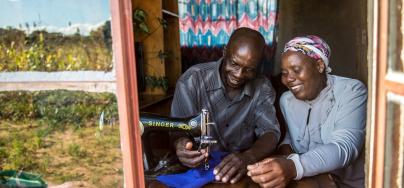 Opheus Dube teaches tailoring skills to his wife Paulina Sibanda in their home in Zvishevane region, Zimbabwe. Credit: Aurelie Marrier d'Unienville / Oxfam