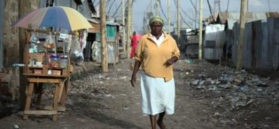 Margaret Mumbua, 46, a domestic worker, heading to work from her house in the informal settlement of Mukuru kwa Reuben, Nairobi, Kenya. 2016. Photo: Allan Gichigi/Oxfam