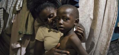 Anges cares for her sick son in her home in Mashimoni village, Kenya.