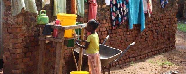 A young girl washes her hands at a tap stand installed by Oxfam, Wau, Cathedral Camp. Credit: Tim Bierley/Oxfam