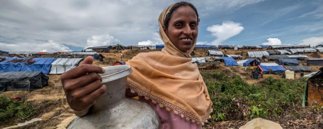 Laila stands near a new Oxfam water pump, Bangladesh. Credit: Tommy Trenchard/Oxfam