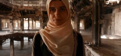 Raghda stands in Mosul University Library. Credit: Charlotte Sawyer/ Oxfam