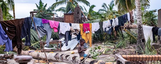 A boy sits amid scenes of destruction in Macomia town after it was hit by tropical cyclone Kenneth.