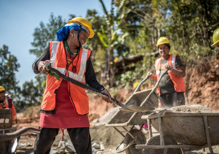 Female construction worker Kaile (20yrs) helps build a house in Kharanitaar village, Nuwakot district, Nepal