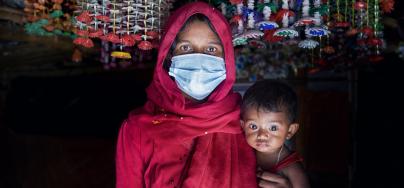 Nur Jahan* with her daughter Ismat* is walking through the narrow alley beside her tent. Rohingya refygee camp. Cox's Bazar, Bangladesh