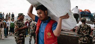 Oxfam volunteer delivering latrines in Nepal, one of 500 volunteers trained to react in the event of an earthquake. Photo: Aubrey Wade/Oxfam