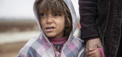 Mariam*, 5, from Raqqa in Syria, walks with her mother through an informal settlement for Syrian refugees near the town of Baalbek in Lebanon's Bekaa Valley, on January 26, 2016. Photo: Sam Tarling/Oxfam 