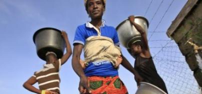 Felicia Ayaawin draws water from the well Oxfam’s partner installed near her home in Kpatua. 