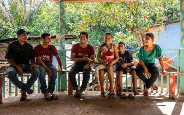 Some of the children and grandchildren of María Isabel Cortés and Benjamín Peña sitting on the porch of their home.