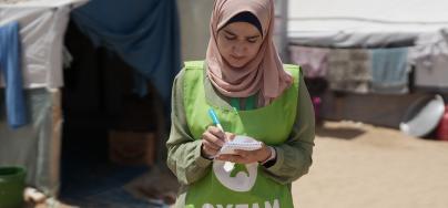 Oxfam's Ghada Alhaddad stands in the Al-Mawasi area, collecting notes and reflections from people on the ground.