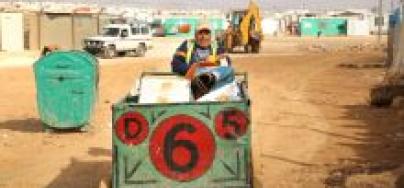 A cash for work volunteer in Za’atari camp delivers materials to Oxfam’s recycling centre. Photo: Alix Buck/Oxfam