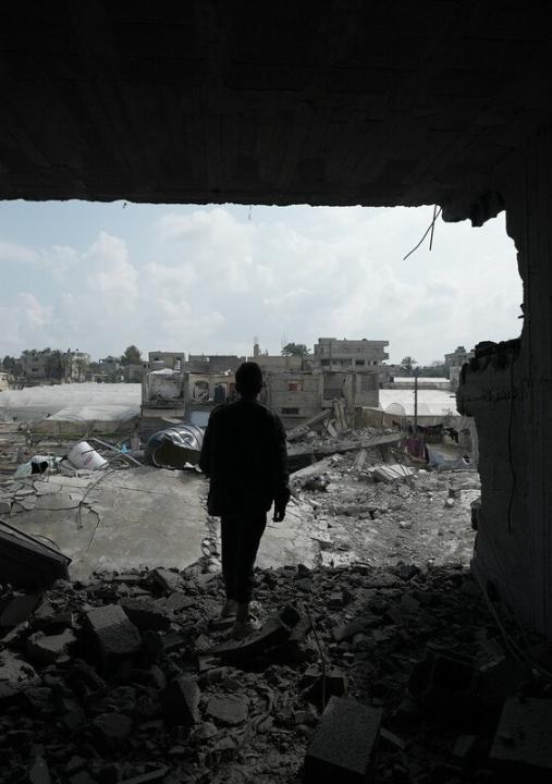 A boy standing on his bombed house by an Israeli airstrike in Rafah that took place in mid-February 2024. a heavy attack by the Israeli military where around 100 Palestinians were killed in one night in Rafah only.