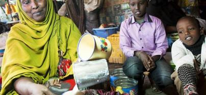 A woman trader in Hargeisa market serves a cup of fresh camel’s milk. Small-scale business women often rely on remittances as start-up money for their stalls. Photo: Petterik Weggers/Oxfam