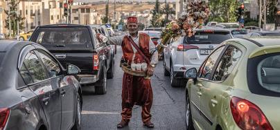 Abu Ahmad, 70 years old. Abu Ahmad selling juice in the streets of Amman on a hot summer day to provide for his family. 